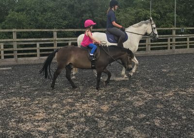 Two young riders in arena